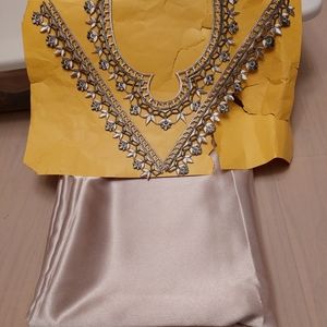 Brand new satin fabric with a beautiful embroidered neckline piece